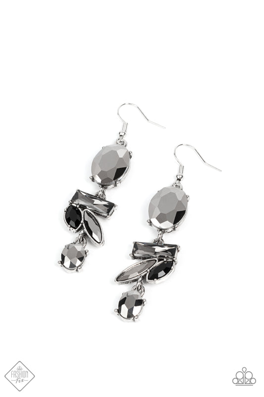 A stunning faceted hematite gem, set in pronged silver fittings, gives way to an edgy collection of lustrous hematite, smoky, and black rhinestones creating a modern statement-making lure. Earring attaches to a standard fishhook fitting.  Sold as one pair of earrings.