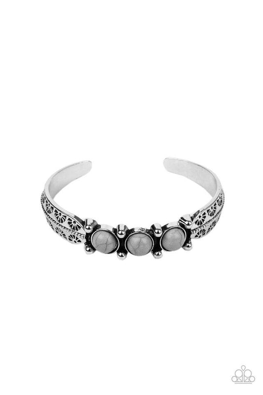 A trio of earthy Sleet stones are encrusted along the center of a dainty silver studded cuff stamped in tribal inspired details for a seasonal flair.  Sold as one individual bracelet.