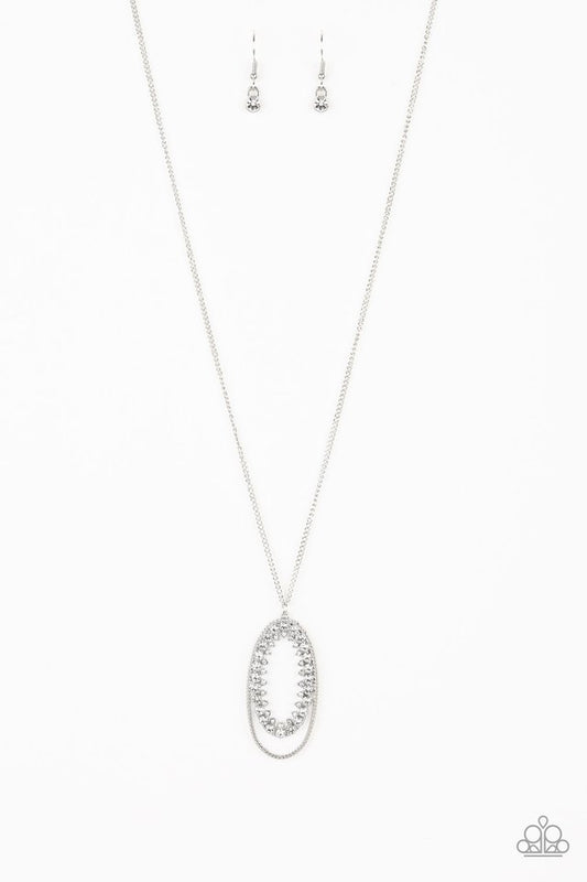 Ringed in a studded silver frame, glittery white rhinestones collect into glamorous pendant at the bottom of a lengthened silver chain for a refined flair. Features an adjustable clasp closure.  Sold as one individual necklace. Includes one pair of matching earrings.
