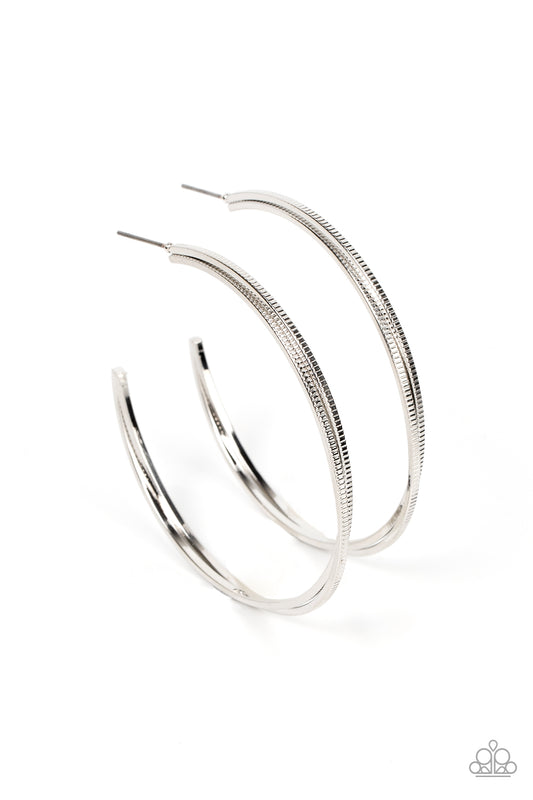 Etched in ribbed texture, two glistening silver bars gently curve and stack into an oversized hoop for a classic metallic look. Earring attaches to a standard post fitting. Hoop measures approximately 2" in diameter.  Sold as one pair of hoop earrings.