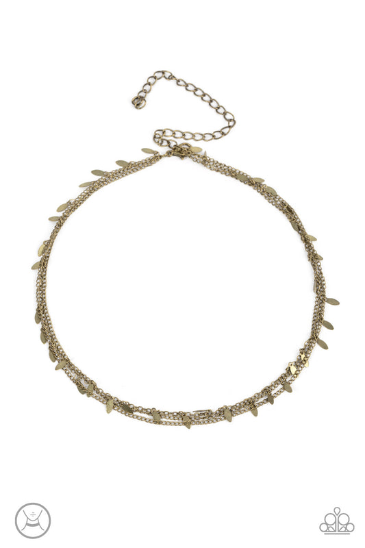 Infused with two dainty rows of antiqued brass chains, a row of brass oval discs glisten around the neck for a playfully rustic look. Features an adjustable clasp closure.  Sold as one individual choker necklace. Includes one pair of matching earrings.