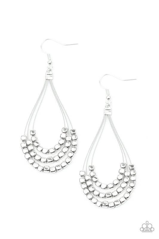Three rows of dainty silver cube beads glides along shiny silver wire, layering into an edgy teardrop lure. Earring attaches to a standard fishhook fitting.  Sold as one pair of earrings.
