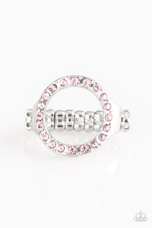 Encrusted in glittery pink rhinestones, a circular frame adorns the finger, creating a glamorous centerpiece. Features a stretchy band for a flexible fit.  Sold as one individual ring.