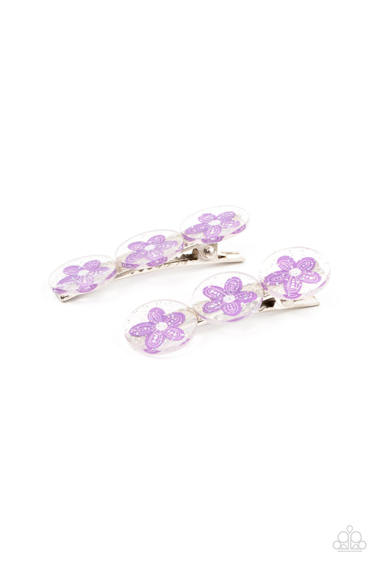 Sprinkled in silvery sparkles, trios of purple flower adorned acrylic discs join into a whimsical pair of hair clips. Features standard hair clips on the back.  Sold as one pair of hair clips.