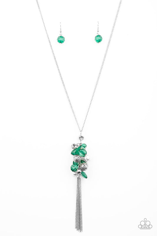 A fabulous collision of Ultramarine Green crystal-like beads, white rhinestones, white pearls, and ornate silver beads delicately cluster at the bottom of a lengthened silver chain for a colorfully vintage look. A silver chain tassel swings from the bottom of the display, adding a flirtatious movement to the whimsical piece. Features an adjustable clasp closure.  Sold as one individual necklace. Includes one pair of matching earrings.