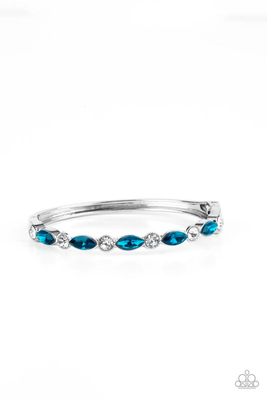 A sparkly collection of round white rhinestones and marquise blue rhinestones alternate across the top of the wrist, coalescing into a stackable bangle-like bracelet. Features a hinged closure.  Sold as one individual bracelet.