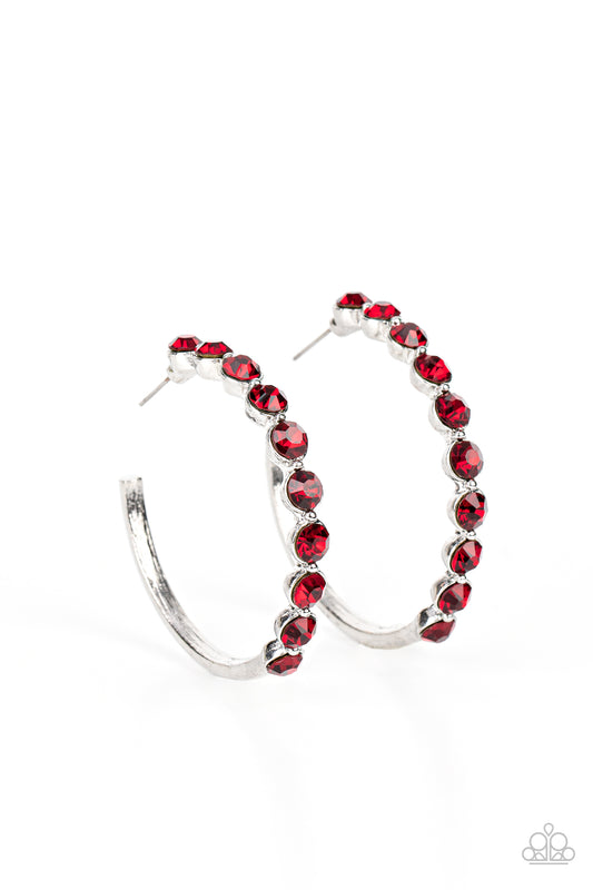 The front of a bold silver hoop is encrusted in fiery red rhinestones, creating a glamorous pop of sparkle. Earring attaches to a standard post fitting. Hoop measures approximately 1 3/4" in diameter.  Sold as one pair of hoop earrings.