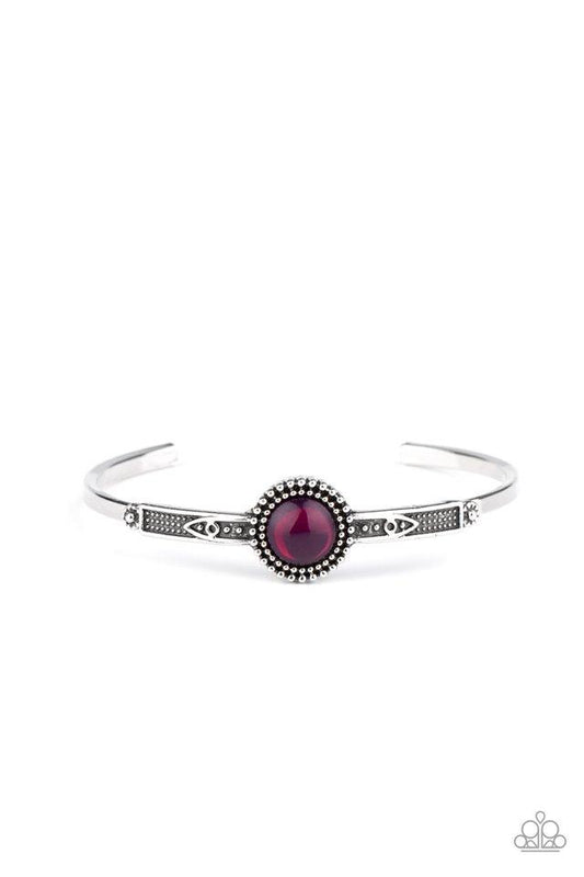 A glassy purple bead is pressed into the middle of a studded silver frame atop a decorative cuff, creating a colorfully dainty display around the wrist.  Sold as one individual bracelet.
