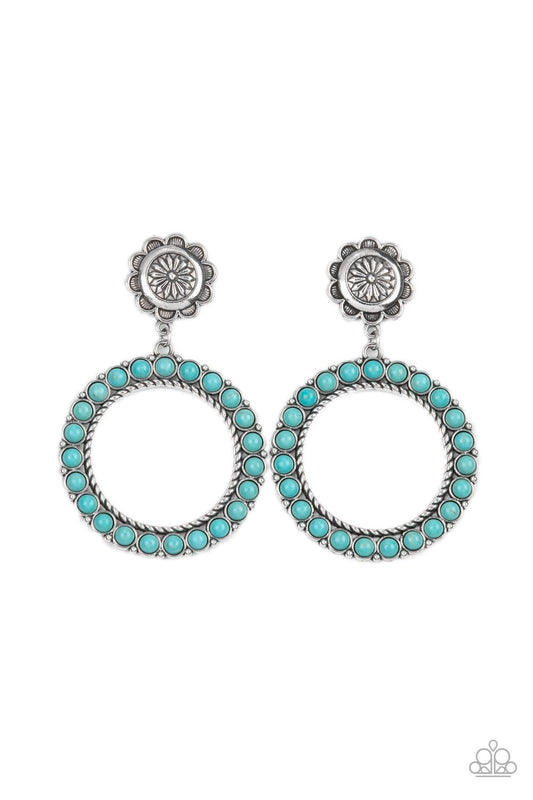 Featuring studded and twisted rope-like silver accents, a turquoise stone dotted hoop swings from the bottom of a rustic silver flower for a whimsically floral fashion. Earring attaches to a standard post fitting.  Sold as one pair of post earrings.