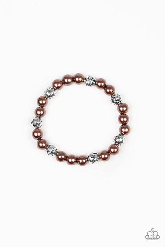 A collection of pearly brown beads and ornate silver beads are threaded along an elastic band around the wrist for a refined fashion.

Sold as one individual bracelet.