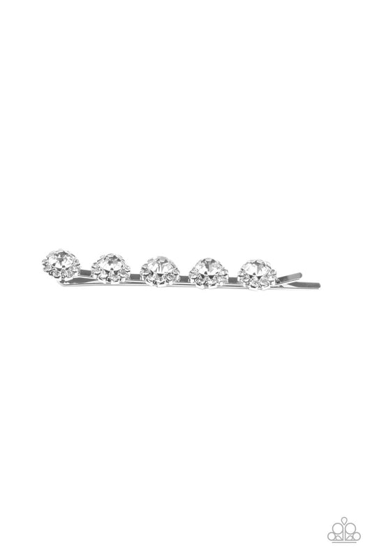 Pressed into silver pronged fittings, a sparkly series of dainty white rhinestones encircle oversized white rhinestones, creating a glitzy floral display.  Sold as one decorative bobby pin.