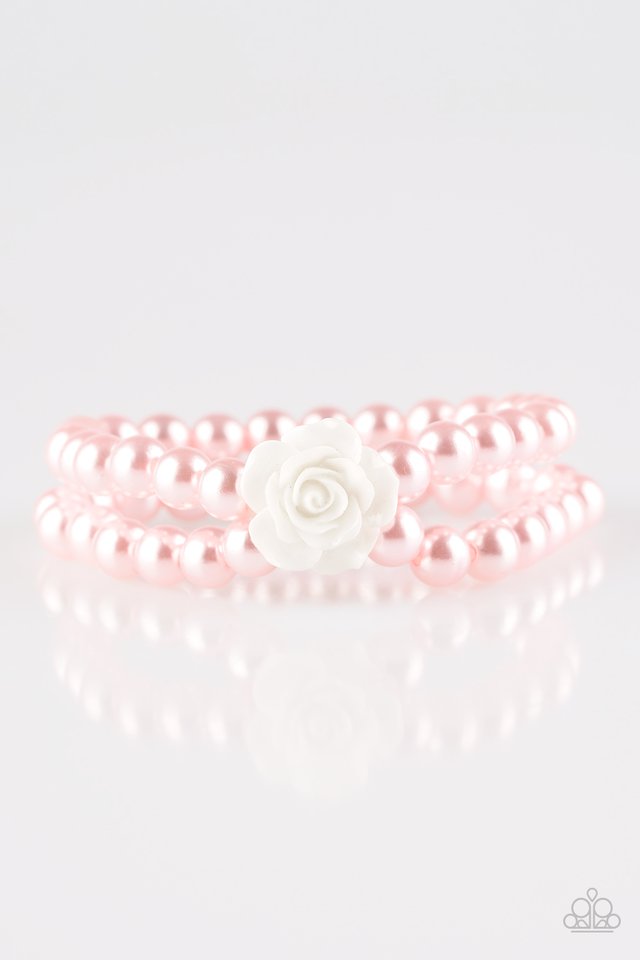 Connected by a flirty white resin rose, classic pink pearls are threaded along stretchy bands around the wrist for a vintage inspired fashion.

Sold as one individual bracelet.