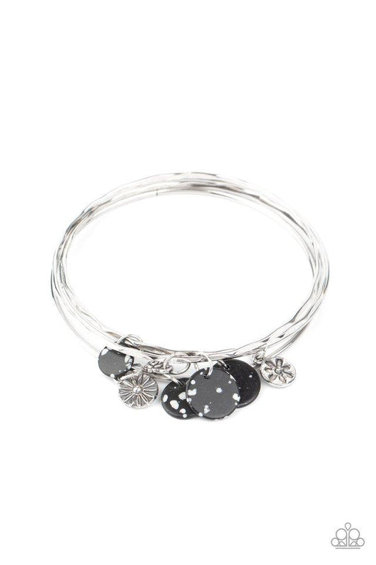 Infused with mismatched silver floral charms and speckled black stone discs, a stack of hammered silver bangles slides along the wrist for a colorful earthy look.  Sold as one individual bracelet.