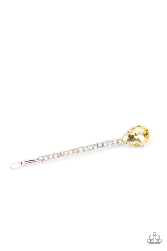 A golden yellow teardrop gem adorns the corner of a bobby pin that is adorned in opalescent rhinestones for a glamorous finish.  Sold as one individual decorative bobby pin.
