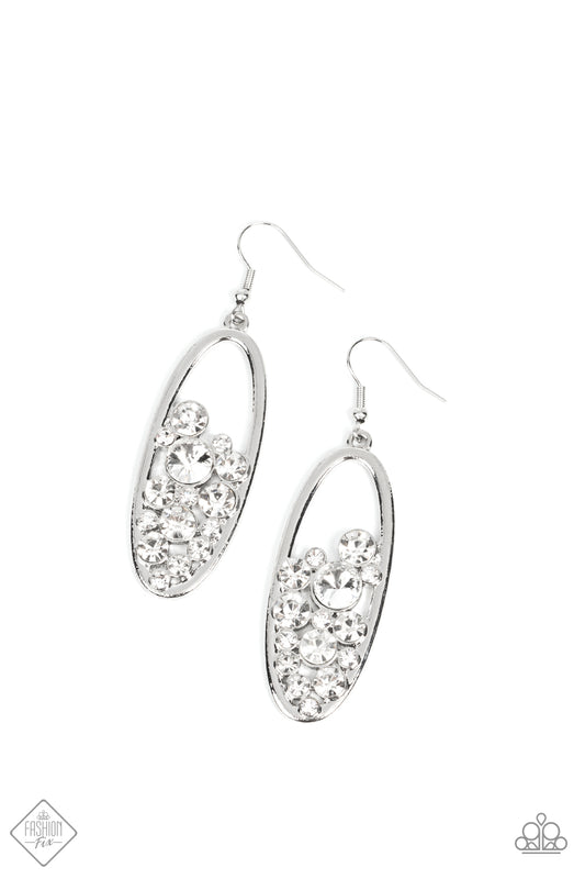 Effervescent stacks of brilliant white rhinestones bubble up inside a simple silver oval frame creating a prismatically stunning lure. Earring attaches to a standard fishhook fitting.  Sold as one pair of earrings.