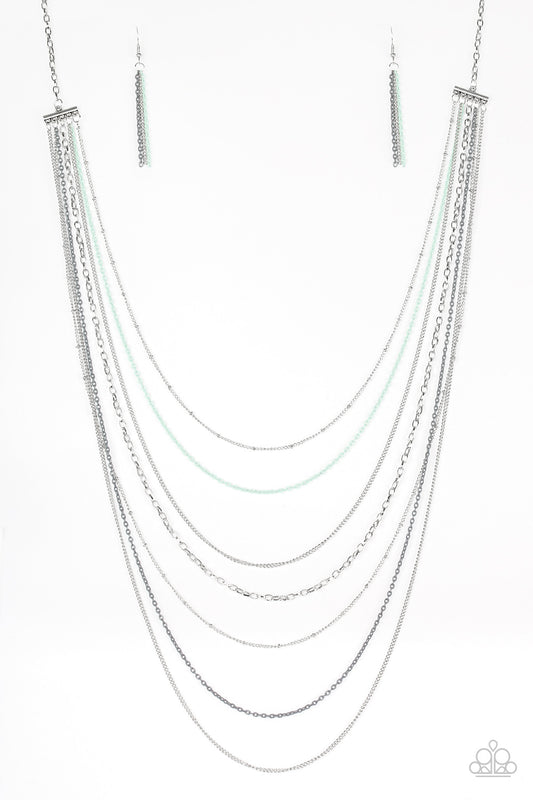 Mismatched silver chains alternate with dainty gray and green chains down the chest, creating a colorful industrial look. Features an adjustable clasp closure.  Sold as one individual necklace. Includes one pair of silver fringe earrings.