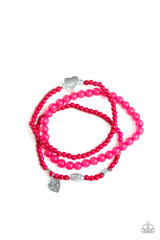 An array of glassy and polished pink beads are threaded along stretchy bands. Infused with silver accents, a collection of silver heart charms and a bead spelling out the word, "love", adorn the beaded strands for a romantic finish.

Sold as one set of three bracelets.