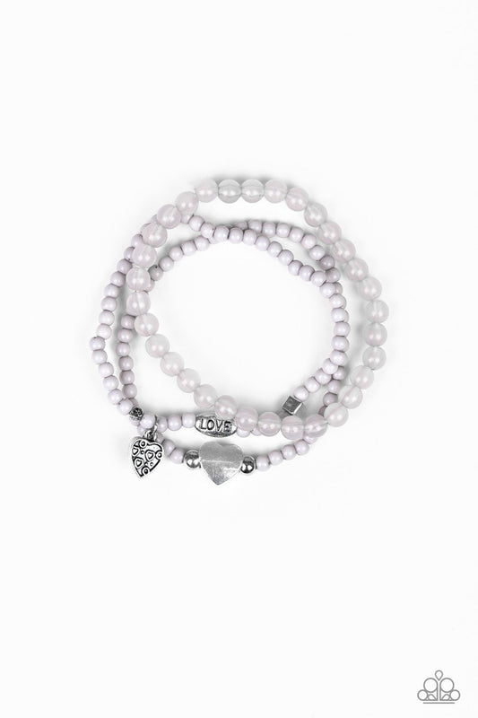 An array of glassy and polished gray beads are threaded along stretchy bands. Infused with silver accents, a collection of silver heart charms and a bead spelling out the word, "love", adorn the beaded strands for a romantic finish.

Sold as one set of three bracelets.