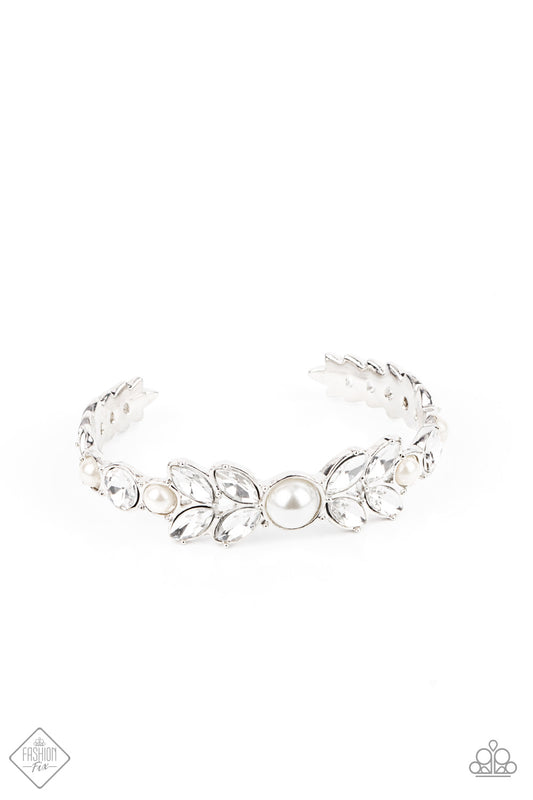 Dotted with bubbly white pearls, an oversized collection of round and marquise style white rhinestones boldly coalesce into a sparkly centerpiece that is flanked by stacks of leafy silver frames that gracefully curve into a decorative cuff.  Sold as one individual bracelet.