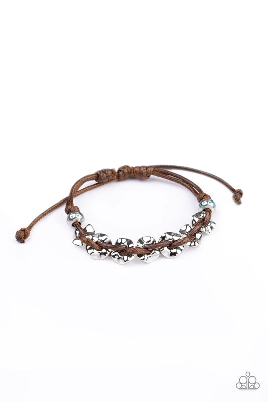 Shiny brown cording weaves through hammered silver beads around the wrist for an urban look. Features an adjustable sliding knot closure.  Sold as one individual bracelet.