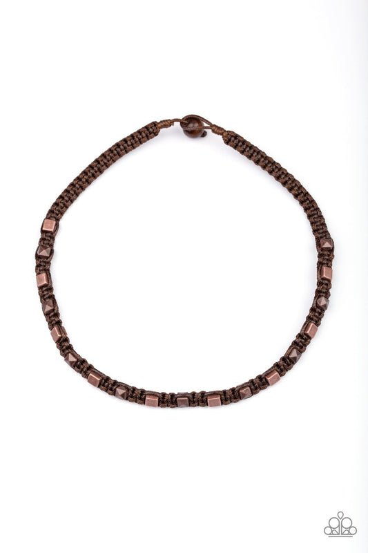 Stamped in edgy geometric patterns, rustic silver rings are knotted in place along shiny brown cording that loops around the neck for a rugged look. Features a button loop closure.  Sold as one individual necklace.