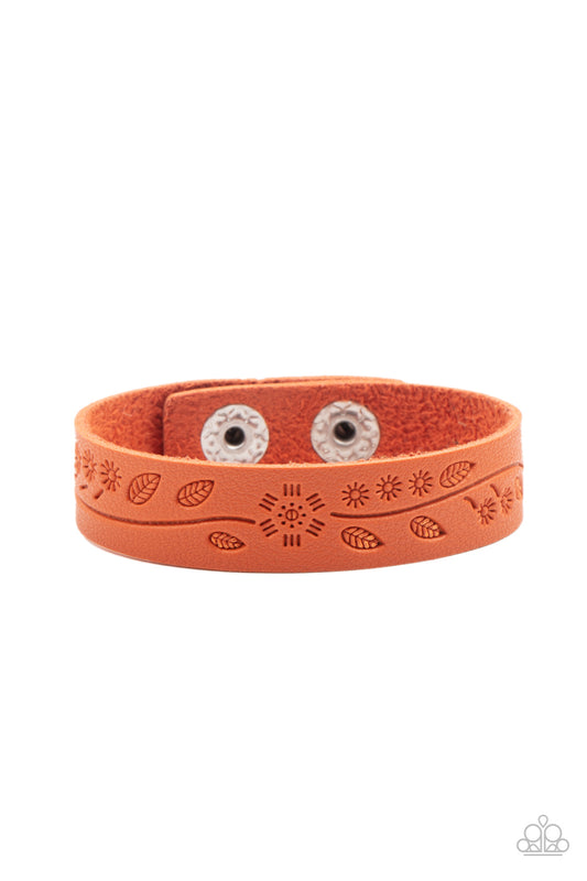 Stamped in a leafy southwestern inspired pattern, a rustic orange leather band wraps around the wrist for a colorfully seasonal look. Features an adjustable snap closure.  Sold as one individual bracelet.