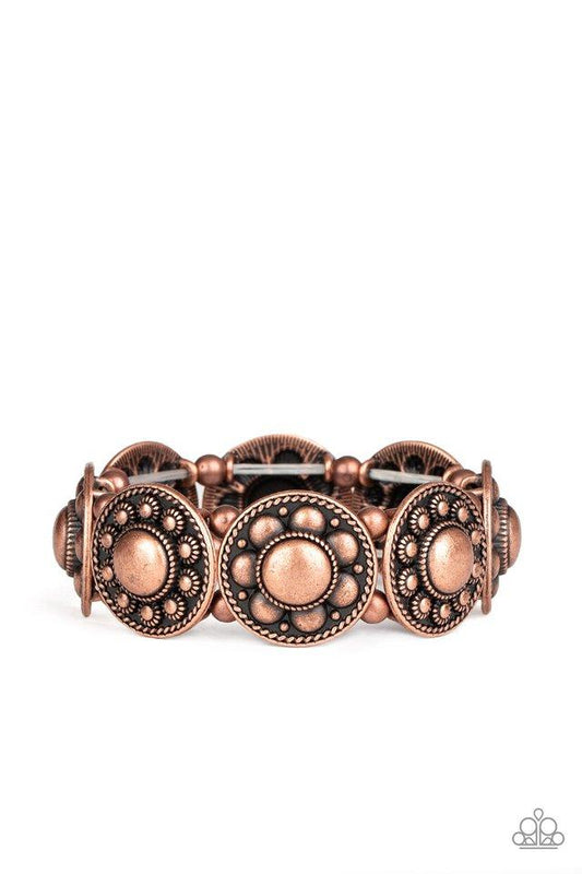 Studded and dotted in decorative floral patterns, antiqued copper frames are threaded along stretchy bands around the wrist for a seasonal flair.  Sold as one individual bracelet.