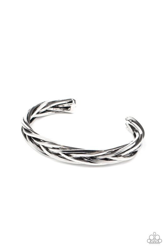 Brushed in an antiqued finish, rustic silver bars weave and braid into an edgy cuff around the wrist.  Sold as one individual bracelet.