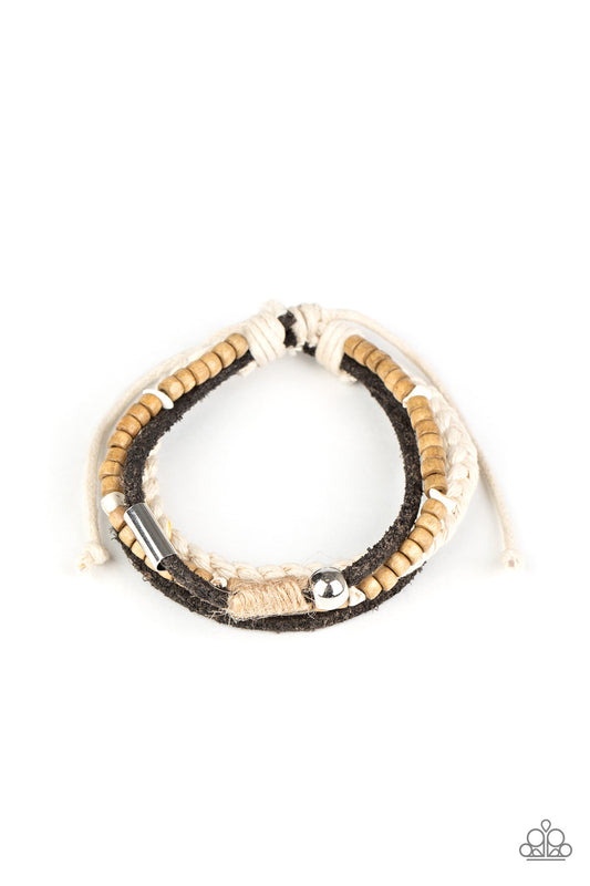 Featuring silver, stone, and wooden beaded accents, a mismatched collection of suede and twine-like braided bands layer across the wrist for an earthy look. Features an adjustable sliding knot closure.  Sold as one individual bracelet.