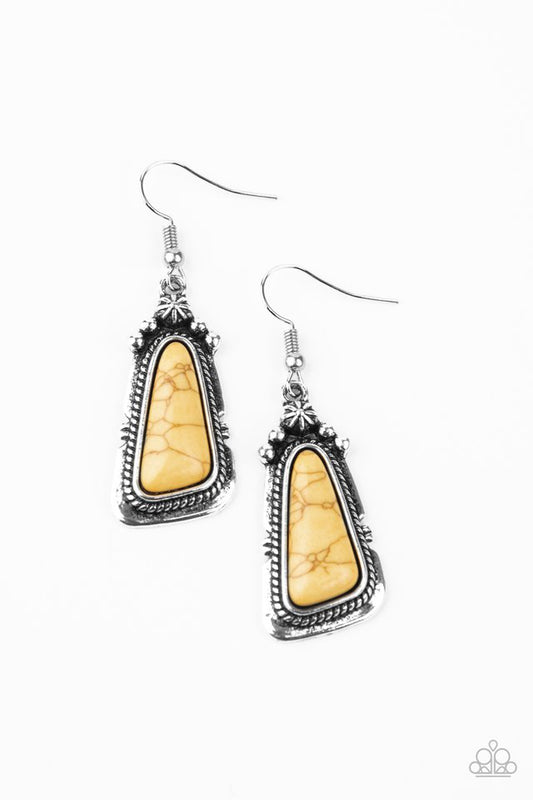 An imperfect yellow stone is pressed into the center of a studded silver frame featuring silver rope-like texture. Earring attaches to a standard fishhook fitting.  Sold as one pair of earrings.
