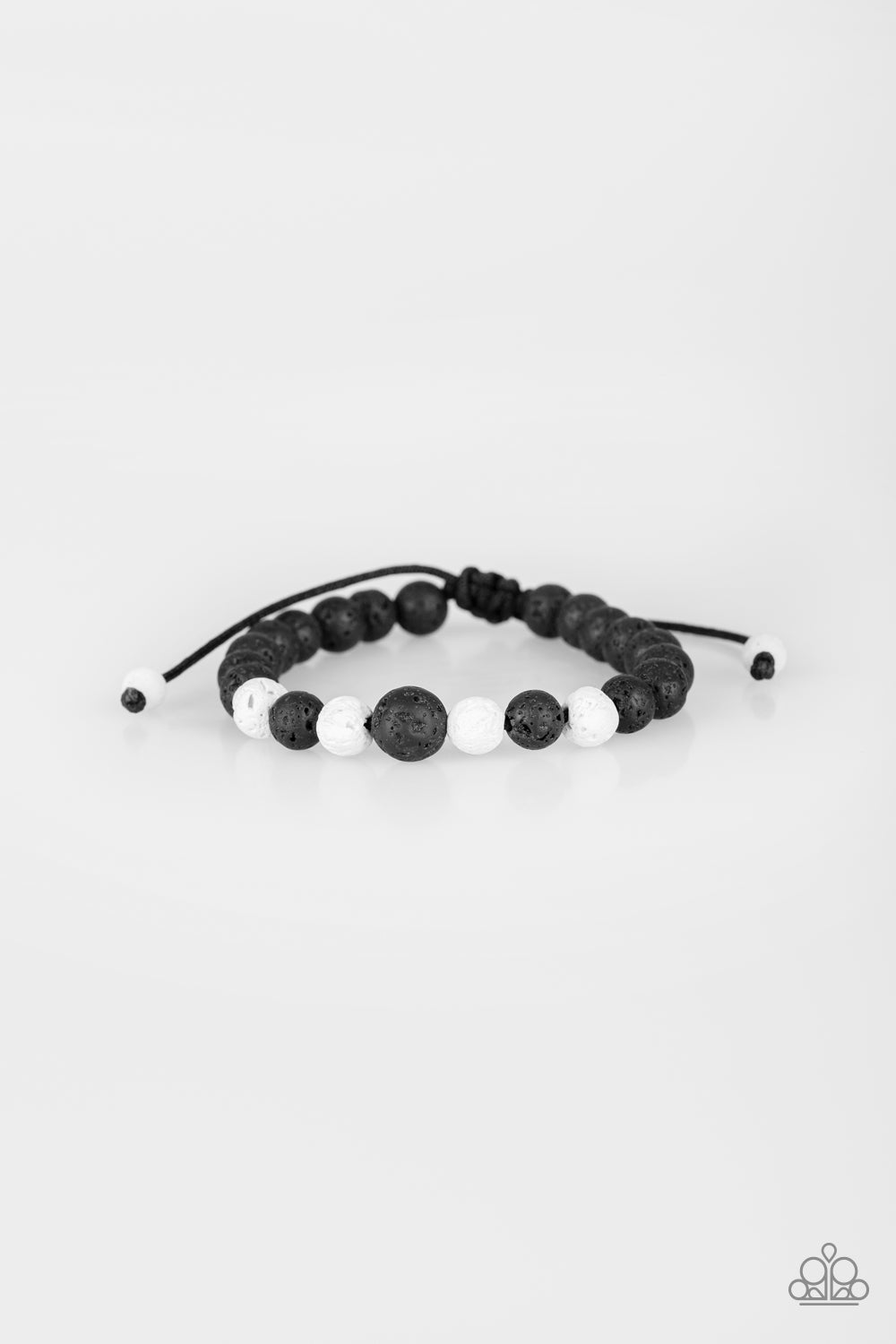A collection of black and white lava rocks are threaded along a shiny cord around the wrist for a seasonal look. Features an adjustable sliding knot closure.  Sold as one individual bracelet.