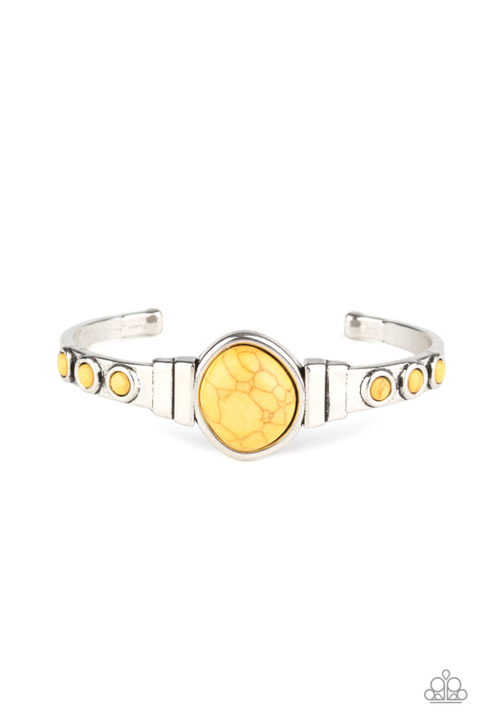 Dotted in dainty yellow stones, a dainty silver cuff attaches to an asymmetrical yellow stone centerpiece for an earthy flair.  Sold as one individual bracelet.