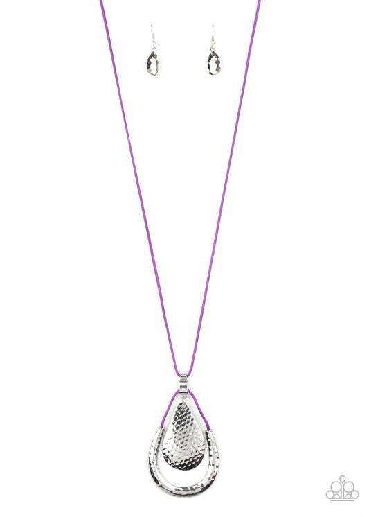 Attached to a shiny silver fitting, a hammered silver teardrop swings from the top of a shiny purple cord pendant featuring a hammered silver accent. The stacked pendants swing from the bottom of a lengthened piece of purple cord for a colorfully trendy look. Features an adjustable clasp closure.  Sold as one individual necklace. Includes one pair of matching earrings.