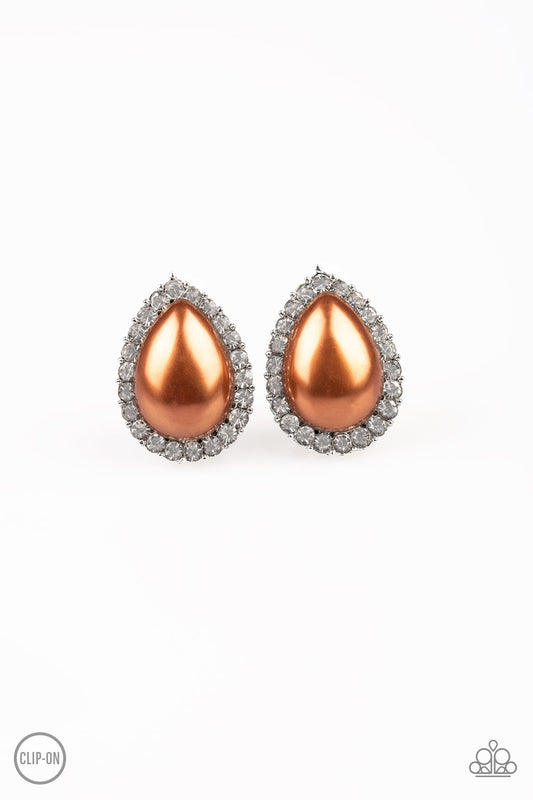 A ring of glassy white rhinestones spins around a pearly brown teardrop bead center, creating a timeless frame. Earring attaches to a standard clip-on earring.  Sold as one pair of clip-on earrings.