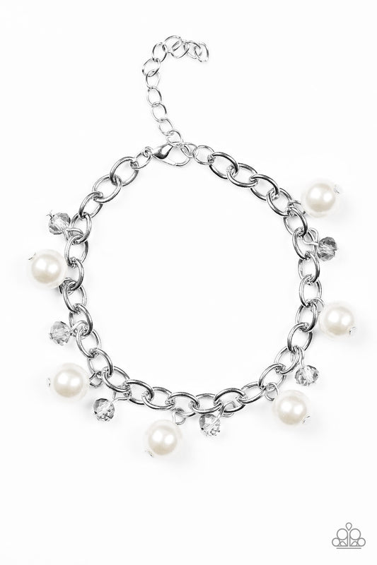 Classic white pearls and smoky crystal-like beads dangle from a shimmery silver chain, creating a refined fringe around the wrist. Features an adjustable clasp closure.  Sold as one individual bracelet.