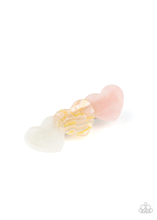 Featuring polished and shell-like finishes, a trio of white, multicolored, and pink heart-shaped acrylic frames delicately overlap into a charming frame. Features a standard hair clip on the back.  Sold as one individual hair clip.