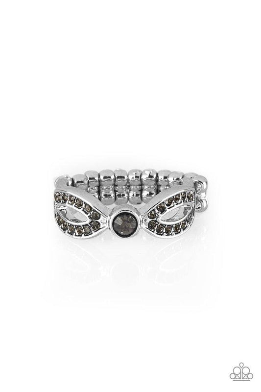 Encrusted in smoky rhinestones, glistening silver ribbons loop away from a dazzling rhinestone center for a refined look. Features a dainty stretchy band for a flexible fit.  Sold as one individual ring.