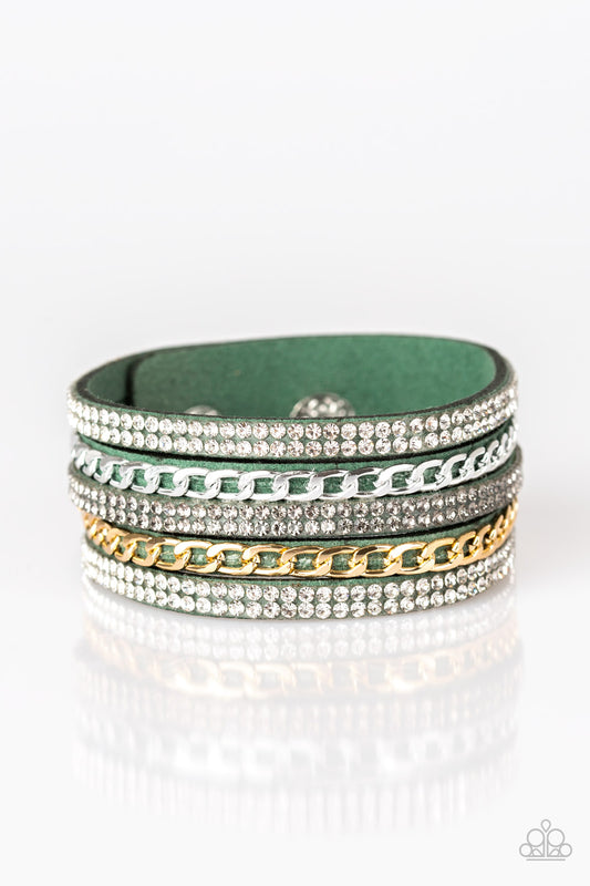 Glassy white and smoky rhinestones are encrusted along strands of green suede. Glistening silver and gold chains are added to the bands, adding edgy industrial shimmer to the sassy palette. Features an adjustable snap closure.  Sold as one individual bracelet.
