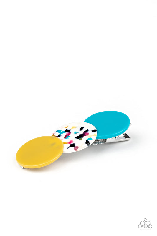 Featuring polished and shell-like finishes, a trio of yellow, multicolored tortoise shell, and blue acrylic circles delicately overlap into a bubbly frame. Features a standard hair clip on the back.  Sold as one individual hair clip.