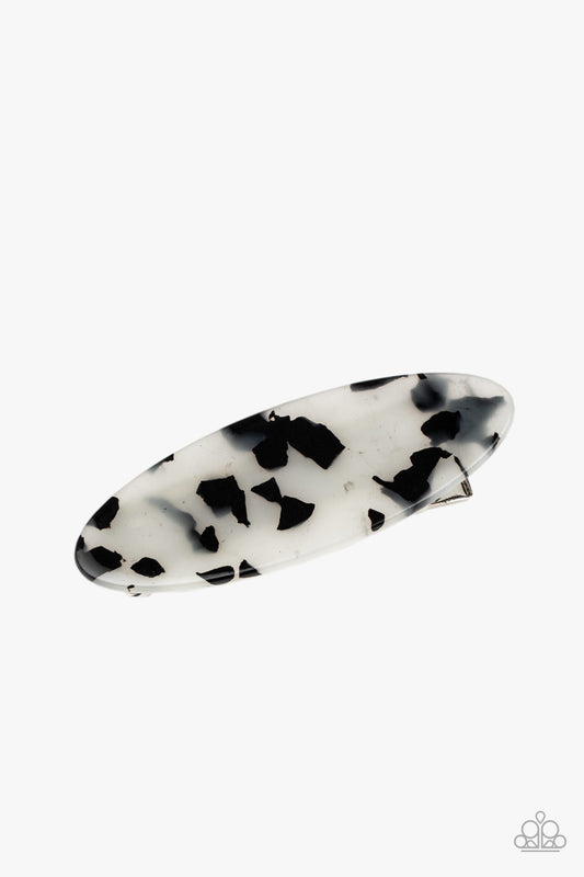 Featuring a white and black tortoise shell finish, an oval acrylic frame pulls back the hair for a retro look. Features a standard hair clip on the back.  Sold as one individual hair clip.