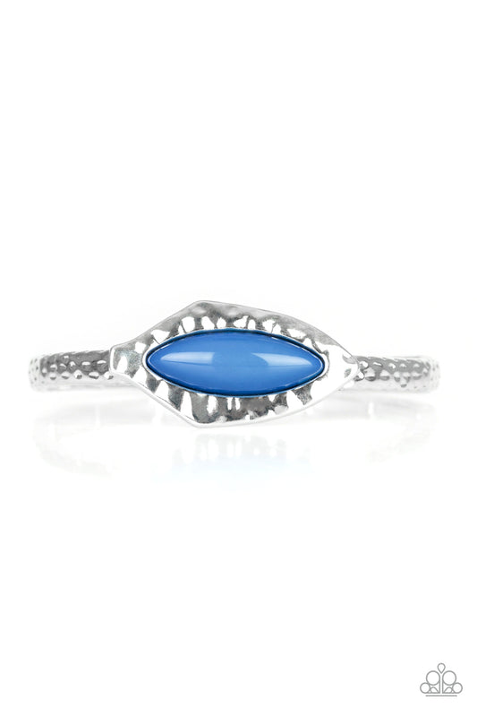 A collection of hammered silver frames are threaded along a stretchy band around the wrist. Infused with a shiny blue beaded center, an abstract frame adorns the center for a handcrafted look.

Sold as one individual bracelet.