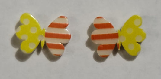 Colorful earrings in assorted colors and shapes. Featuring one striped and one polka dotted wing, the colorful butterfly frames vary in shades of yellow and orange stripes. Earrings attach to standard post fittings.  Sold as one pair of post earrings.