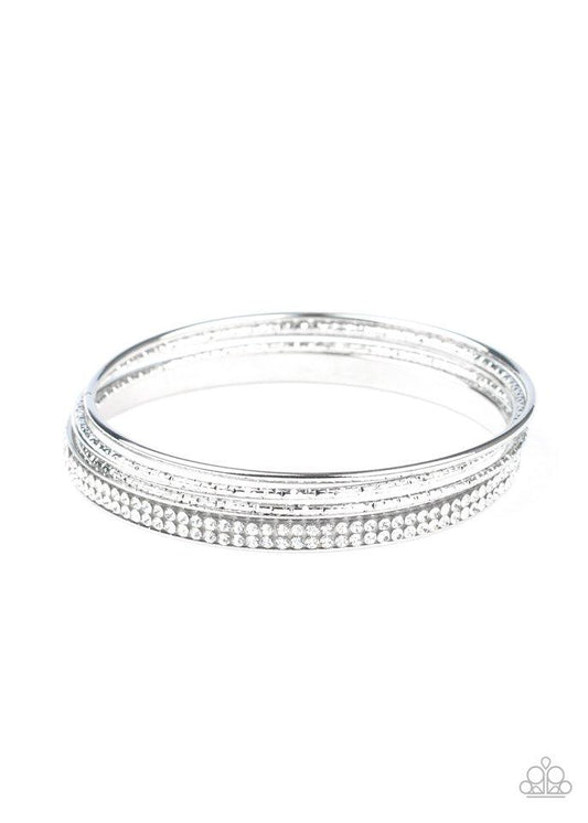 Pairs of smooth and hammered silver bangles join a white rhinestone encrusted bracelet around the wrist, creating an edgy stack of sparkle.  Sold as one set of five bracelets.