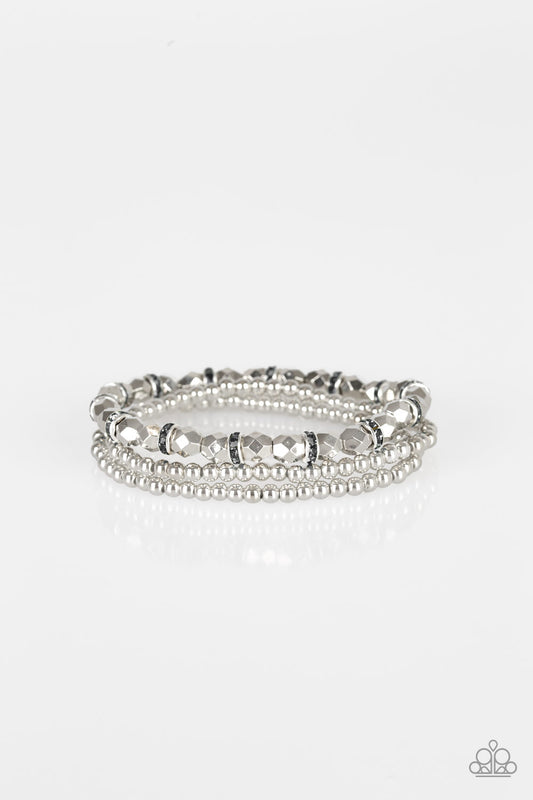 Infused with hematite rhinestone encrusted rings, mismatched dainty silver and faceted silver beads are threaded along stretchy bands for a refined look.

Sold as one set of three bracelets.