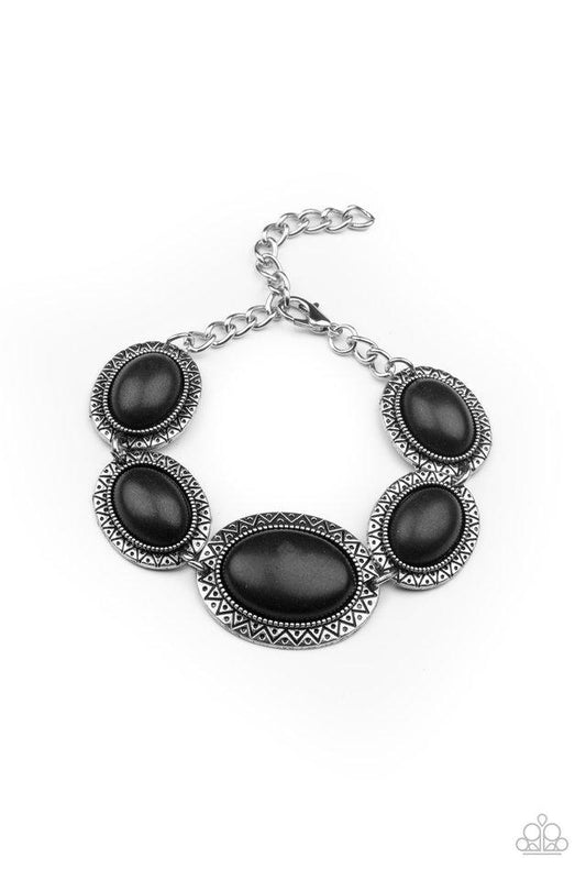 Stamped in dotted sunburst patterns, black oval stone encrusted silver frames delicately link around the wrist for a colorful southwestern flair. Features an adjustable clasp closure.  Sold as one individual bracelet.