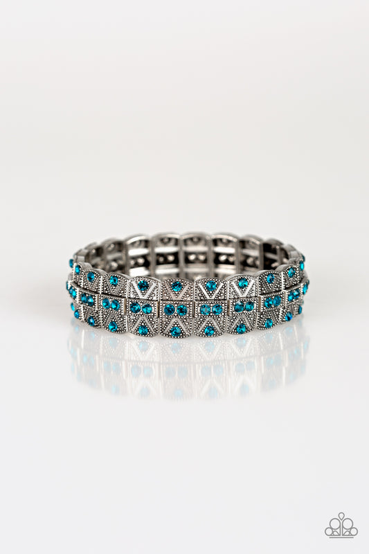 Encrusted in glittery blue rhinestones, ornately studded silver frames are threaded along stretchy bands for an edgy-glamorous look.  Sold as one individual bracelet.