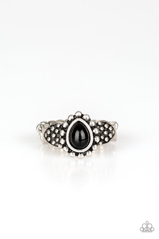 A teardrop black bead is pressed into the center of a dainty silver band radiating with studded patterns for a seasonal look. Features a dainty stretchy band for a flexible fit.  Sold as one individual ring.