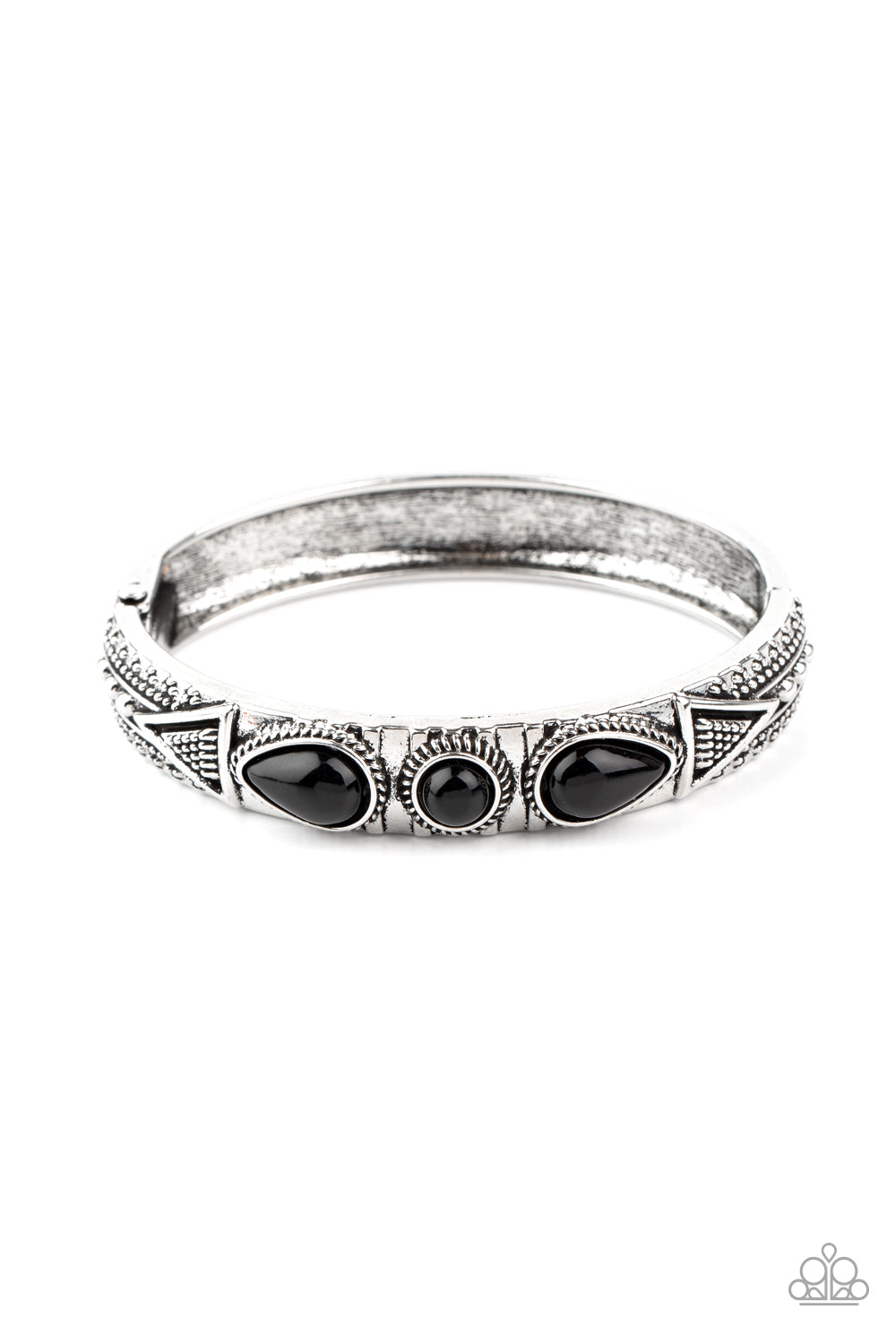 Studded in tribal inspired designs, the top of an antiqued silver cuff-like bangle is embellished with shiny black beads for a colorful look. Features a hinged closure.  Sold as one individual bracelet.