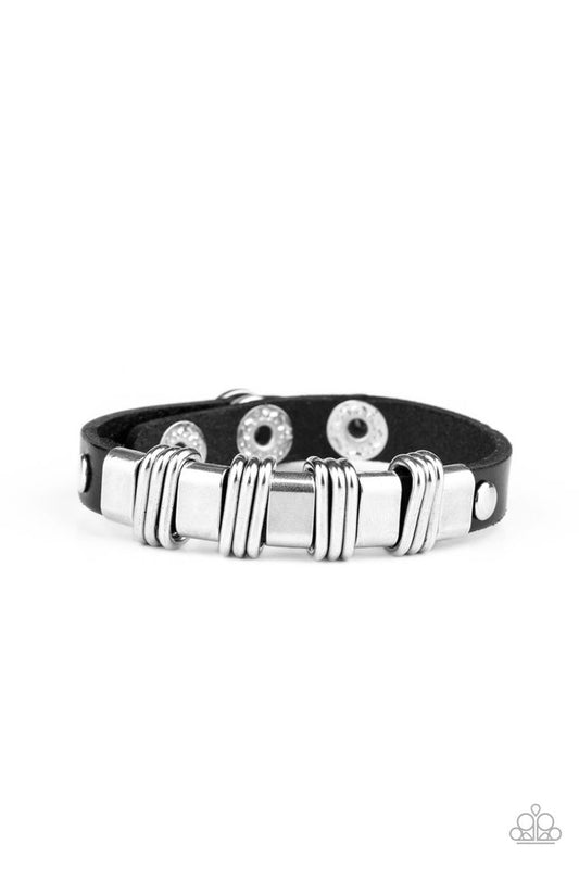 Trios of silver links are held in place with silver fittings along a rustic black leather band for an edgy urban look. Features an adjustable snap closure.  Sold as one individual bracelet.