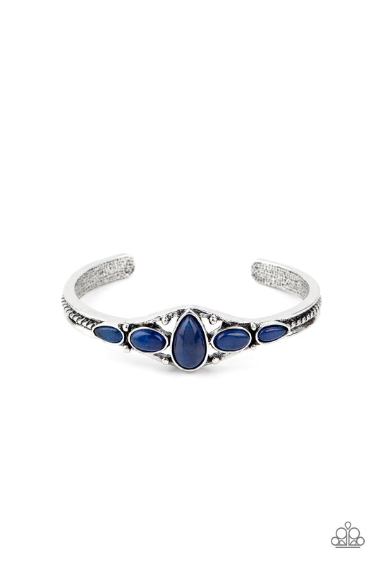 An earthy collection of glassy blue stones are encrusted across the front of a dainty silver cuff for a seasonal flair.  Sold as one individual bracelet.
